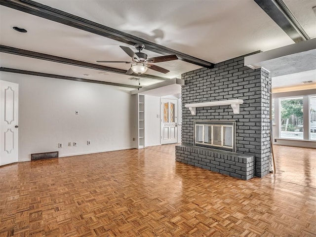 unfurnished living room with beamed ceiling, a brick fireplace, light parquet floors, and ceiling fan