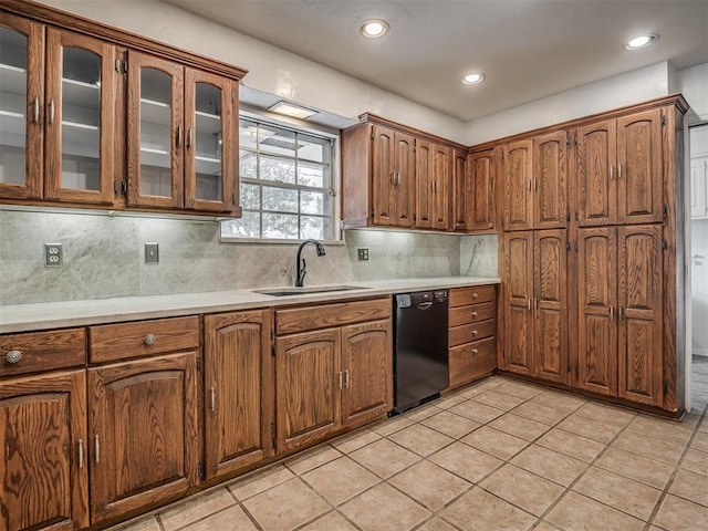 kitchen featuring sink, decorative backsplash, dishwasher, and light tile patterned flooring