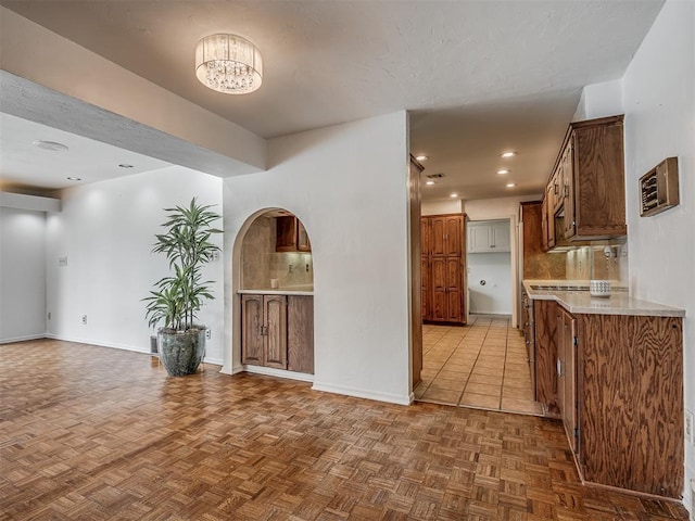 kitchen featuring an inviting chandelier and parquet floors