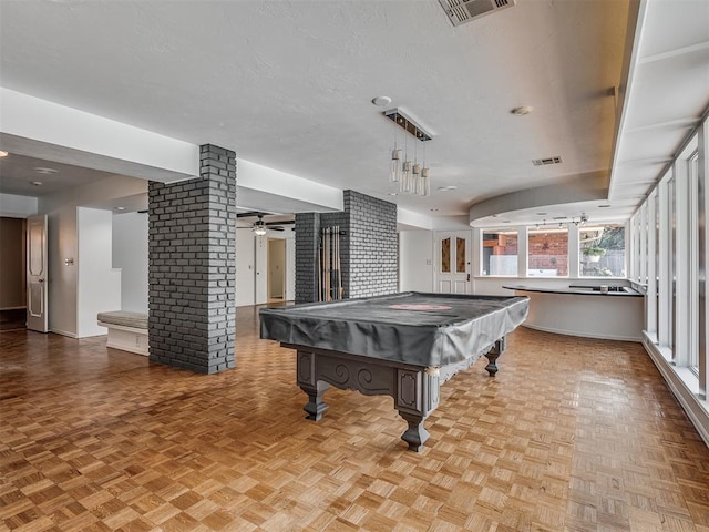 game room with ceiling fan, pool table, light parquet flooring, and a textured ceiling