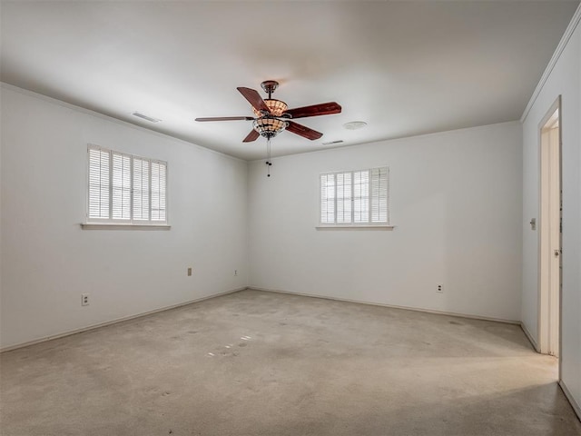 carpeted empty room featuring ornamental molding and ceiling fan