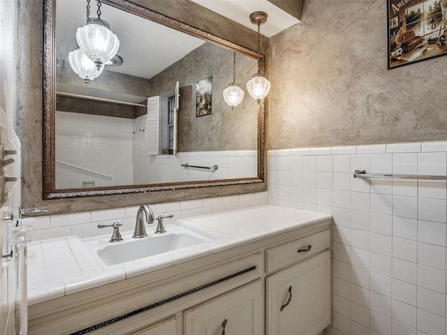 bathroom featuring vanity and tile walls