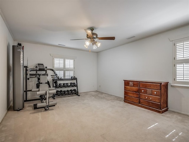 workout room with crown molding, light colored carpet, and ceiling fan