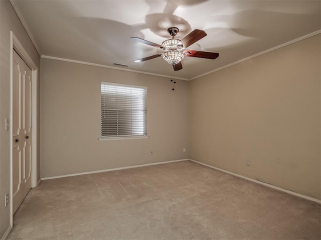 carpeted empty room with ornamental molding and ceiling fan