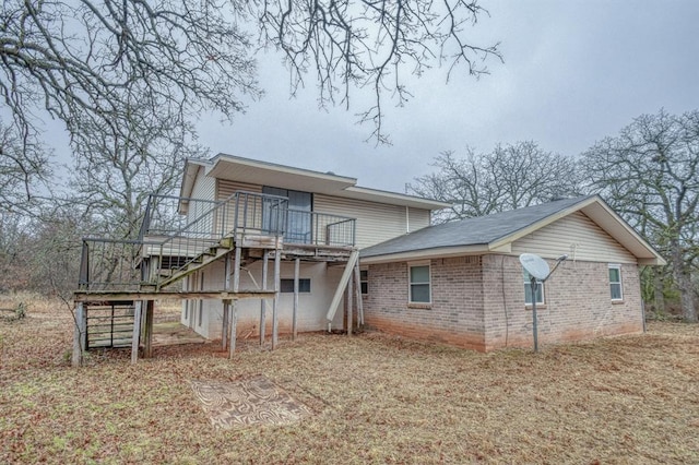 rear view of house featuring a wooden deck