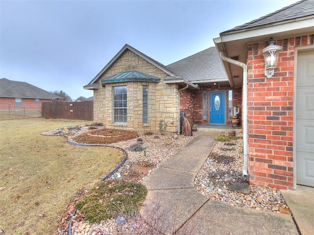 entrance to property with a lawn