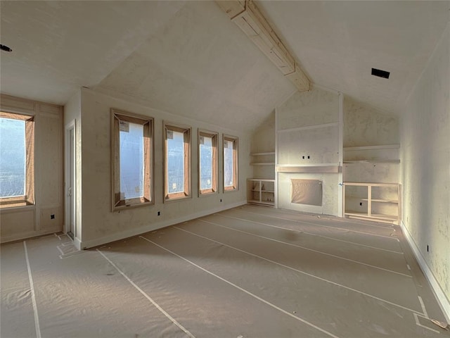 unfurnished living room with built in features and vaulted ceiling with beams