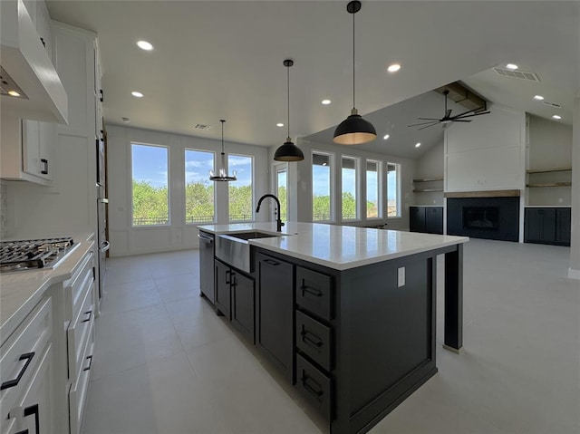 15521 Aparados Way, Edmond, OK 73013 - kitchen with exhaust hood, visible vents, a sink, appliances with stainless steel finishes, and white cabinetry