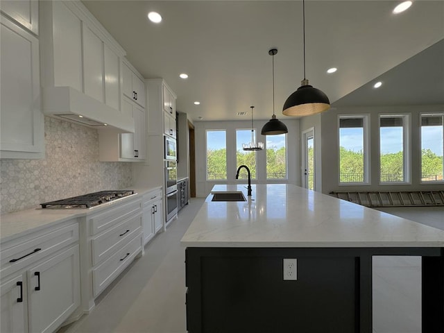 15521 Aparados Way, Edmond, OK 73013 - kitchen with recessed lighting, a sink, a center island with sink, stainless steel gas cooktop, and tasteful backsplash