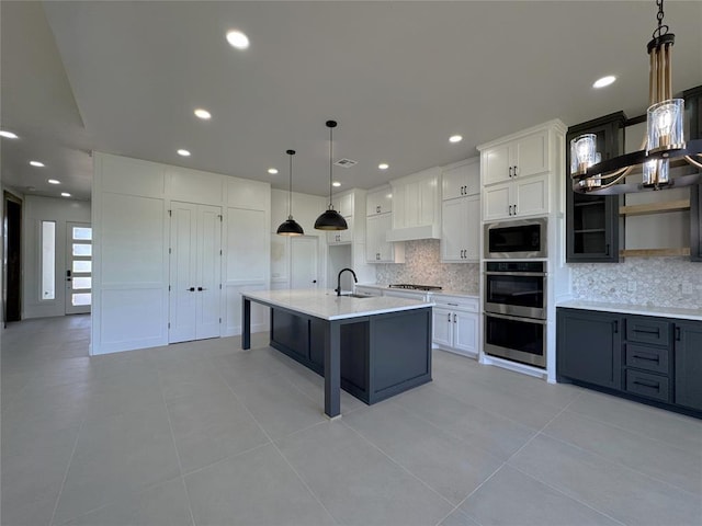 15521 Aparados Way, Edmond, OK 73013 - kitchen featuring built in microwave, light countertops, a sink, gas cooktop, and tasteful backsplash