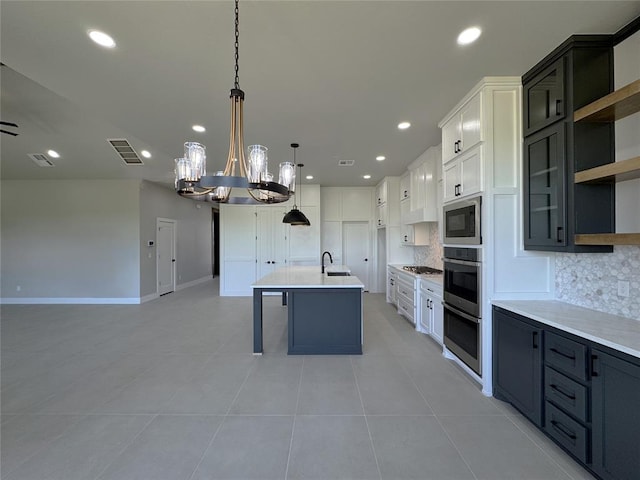 15521 Aparados Way, Edmond, OK 73013 - kitchen featuring open floor plan, backsplash, a notable chandelier, and built in microwave