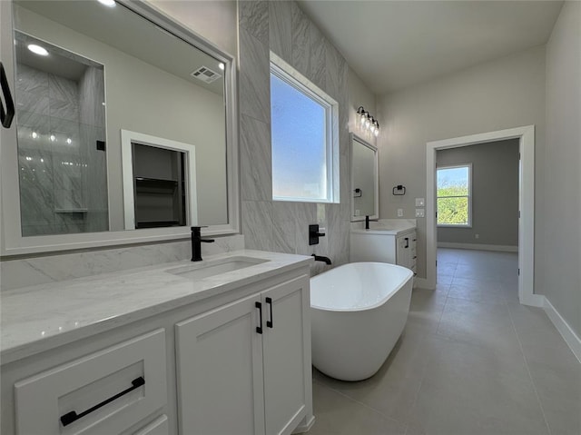 15521 Aparados Way, Edmond, OK 73013 - full bath with tile patterned floors, visible vents, a sink, two vanities, and a freestanding tub