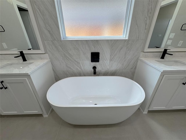 15521 Aparados Way, Edmond, OK 73013 - full bathroom with two vanities, a healthy amount of sunlight, and a sink