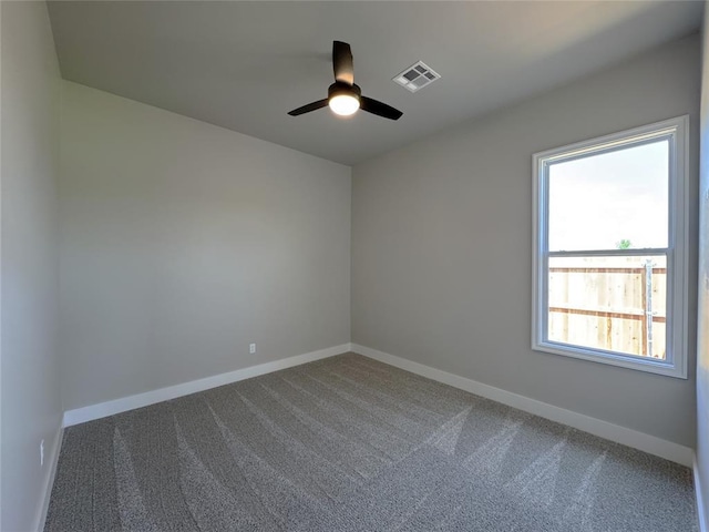 15521 Aparados Way, Edmond, OK 73013 - spare room featuring dark carpet, ceiling fan, baseboards, and visible vents