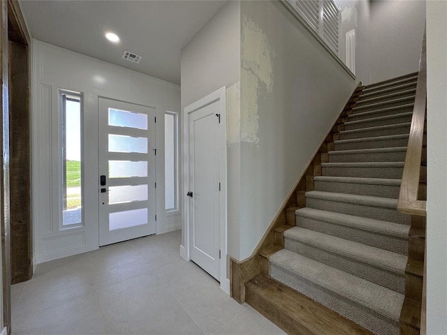 15521 Aparados Way, Edmond, OK 73013 - foyer entrance with tile patterned floors, visible vents, and stairway