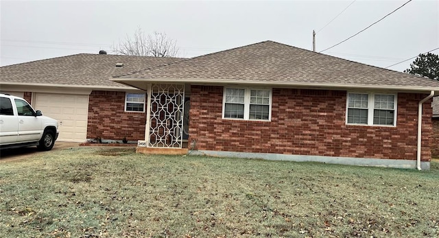 rear view of property featuring a garage and a yard