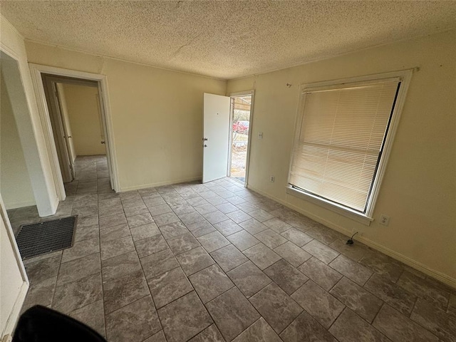 empty room featuring a textured ceiling