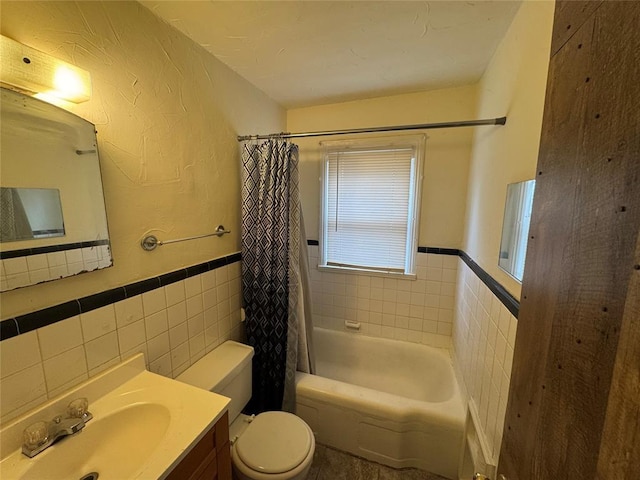 full bathroom featuring vanity, tile walls, shower / tub combo, and toilet