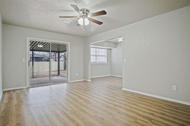 spare room with ceiling fan, light hardwood / wood-style flooring, and a textured ceiling