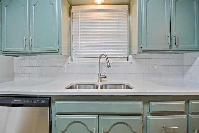 kitchen featuring tasteful backsplash, sink, dishwasher, and green cabinets