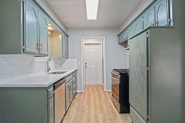 kitchen featuring sink, decorative backsplash, light hardwood / wood-style flooring, and stainless steel appliances