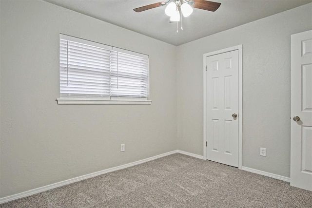 unfurnished room with carpet flooring and ceiling fan