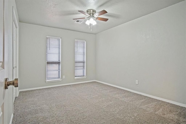 carpeted empty room featuring a textured ceiling and ceiling fan