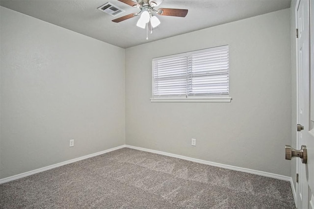 spare room featuring ceiling fan and carpet floors