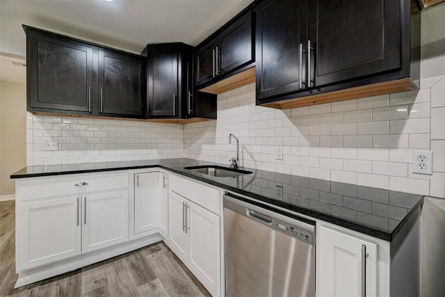 kitchen with sink, light wood-type flooring, backsplash, stainless steel dishwasher, and white cabinets