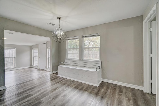 interior space featuring hardwood / wood-style flooring and a chandelier