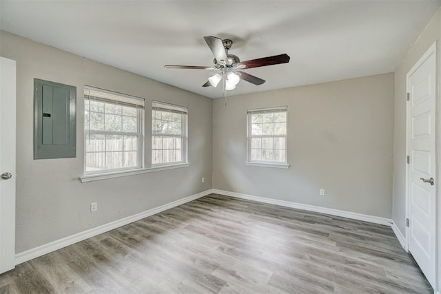 unfurnished bedroom featuring ceiling fan, electric panel, and light hardwood / wood-style flooring