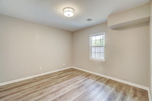 spare room featuring light hardwood / wood-style floors