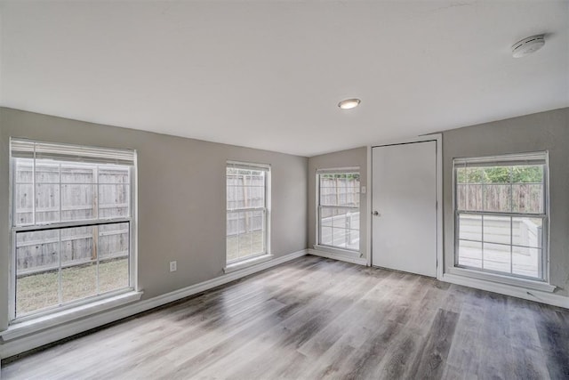 spare room with light hardwood / wood-style flooring