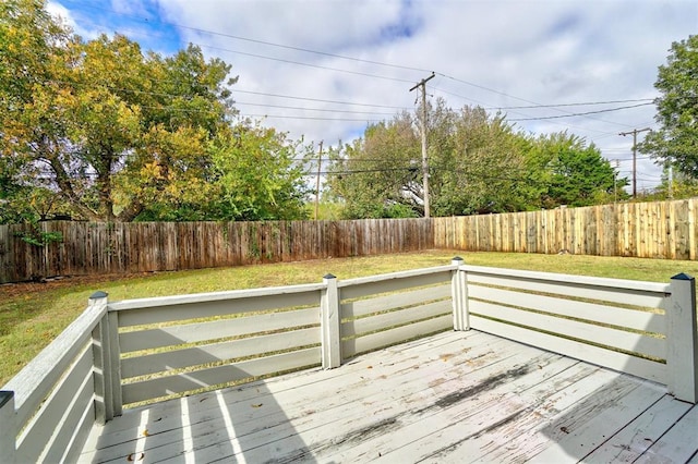 wooden terrace featuring a yard