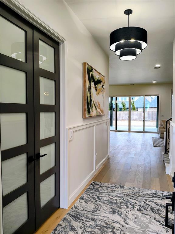 hallway featuring french doors and light wood-type flooring