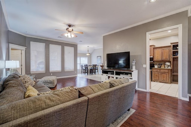 living room with crown molding, light hardwood / wood-style flooring, and ceiling fan