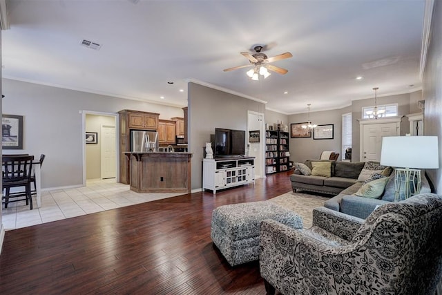 living room featuring crown molding, ceiling fan with notable chandelier, and light wood-type flooring