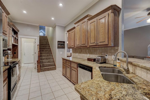 kitchen featuring sink, ornamental molding, light stone countertops, and appliances with stainless steel finishes