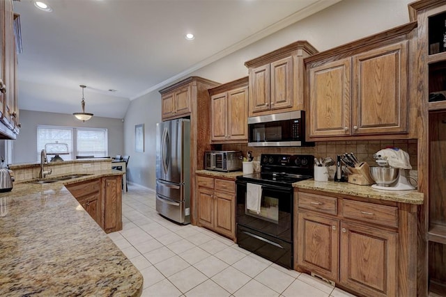 kitchen with sink, light tile patterned floors, stainless steel appliances, decorative backsplash, and decorative light fixtures