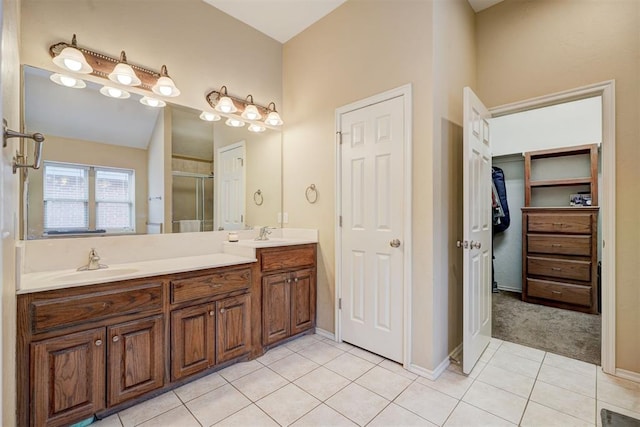 bathroom with vanity, a shower with shower door, and tile patterned flooring