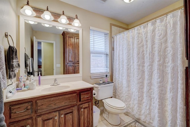 bathroom featuring tile patterned floors, toilet, and vanity