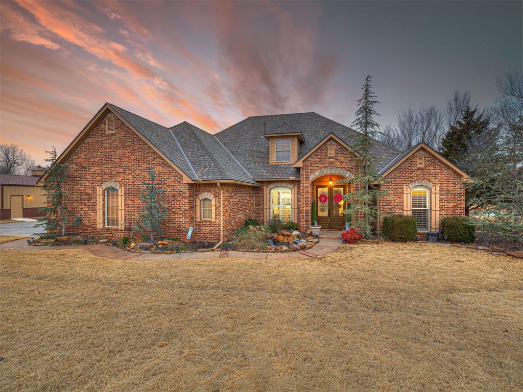 view of front property with french doors and a lawn