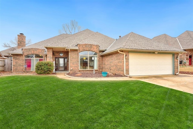 view of front of home with a garage and a front lawn