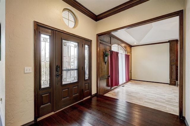 entrance foyer with crown molding and hardwood / wood-style floors