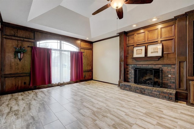 unfurnished living room featuring ceiling fan, lofted ceiling, and a fireplace