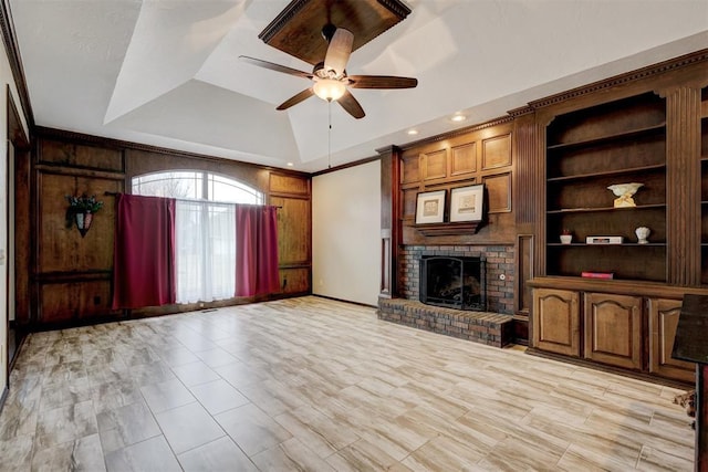 unfurnished living room with vaulted ceiling, ornamental molding, ceiling fan, and a fireplace