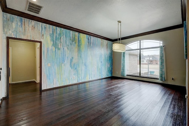 interior space with dark wood-type flooring, ornamental molding, and a textured ceiling