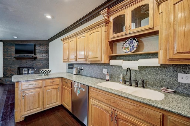 kitchen with sink, ornamental molding, stainless steel dishwasher, light stone counters, and dark wood-type flooring