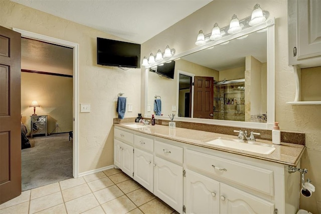 bathroom with walk in shower, tile patterned floors, and vanity