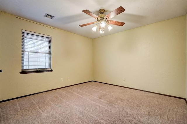 spare room featuring ceiling fan and carpet